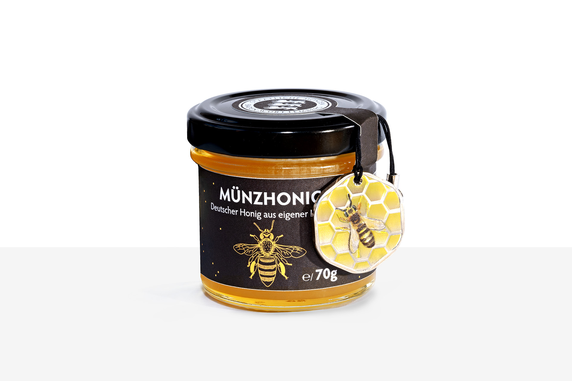 Münzhonig im 70g Glas mit wabenförmiger kolorierter Medaille